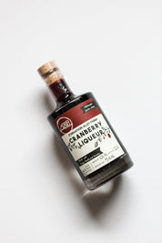 Bottle of cranberry liqueur on a white background